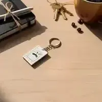 Small white ghost keychain on a desk