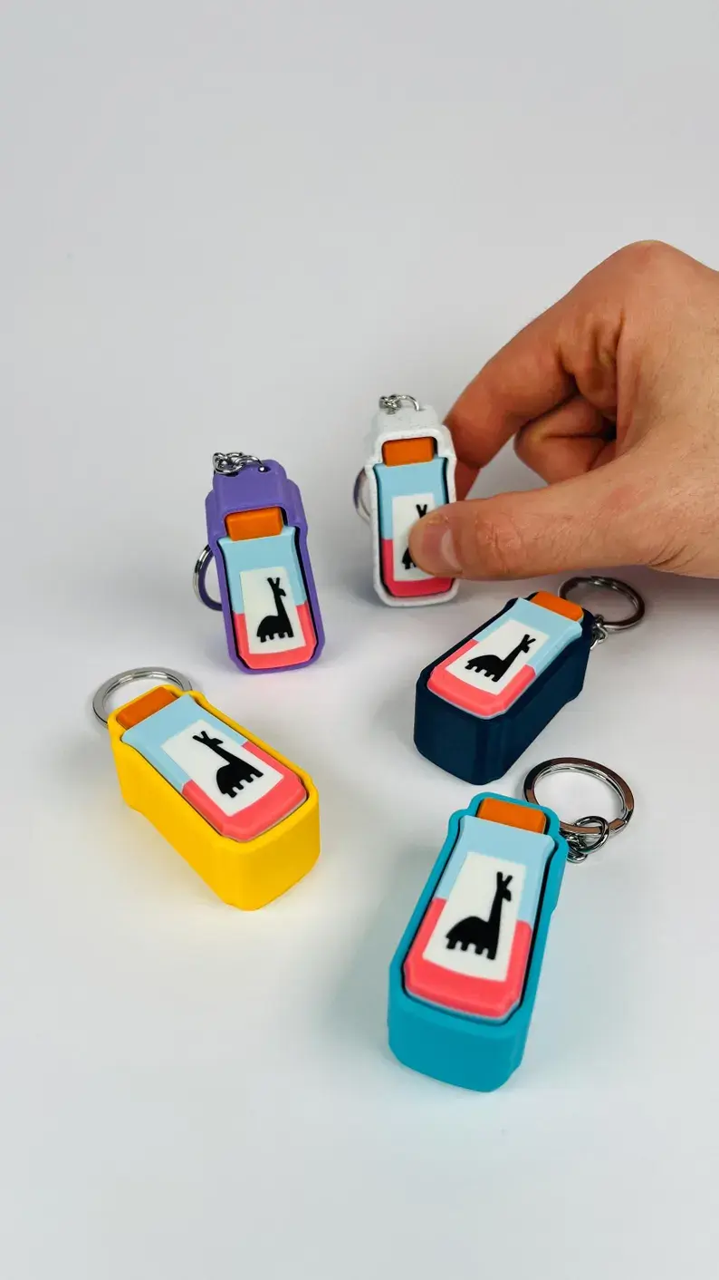 Colorful llama potion fidget keychain held in a hand